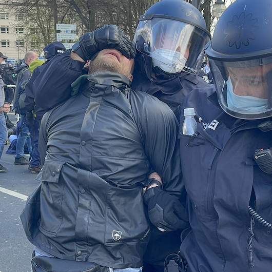 Alman polisi hükümetin Covid-19 politikasını protesto eden göstericileri yerlerde sürükledi