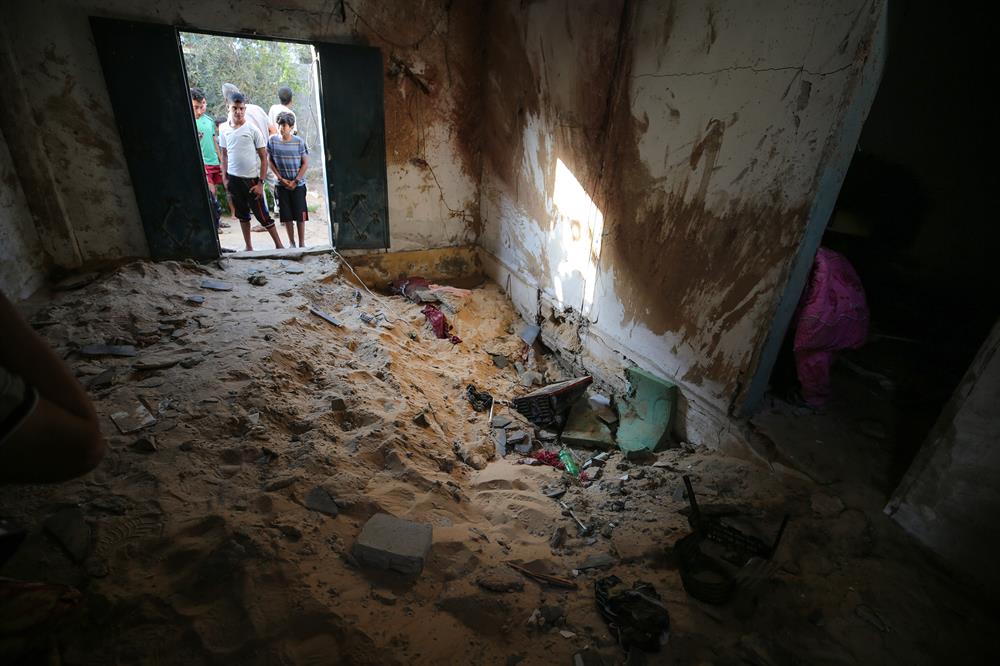 Palestinians insect the damage after warplanes belonging to Israeli army carried out an airstrike over residential areas in Deir Al-Balah, Gaza.
