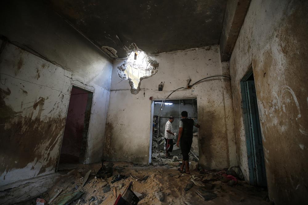 Palestinians insect the damage after warplanes belonging to Israeli army carried out an airstrike over residential areas in Deir Al-Balah, Gaza.