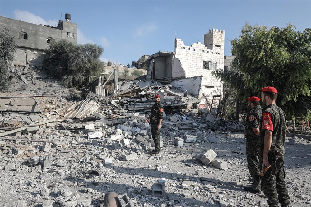 Security forces belonging to Hamas inspect the site after Israeli army conducted air strikes towards Gaza City on the grounds that 36 rockets were thrown to Israel in Gaza.