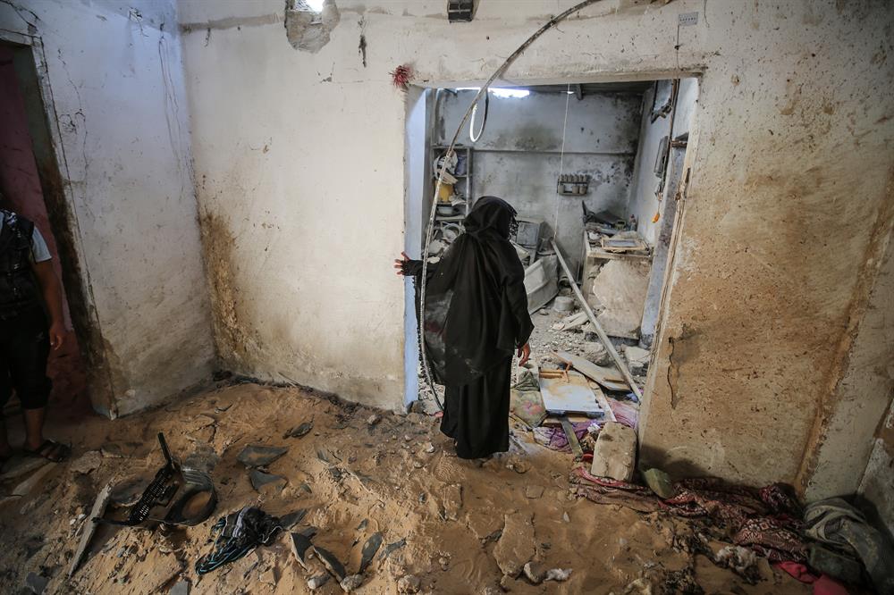 Palestinians insect the damage after warplanes belonging to Israeli army carried out an airstrike over residential areas in Deir Al-Balah, Gaza.