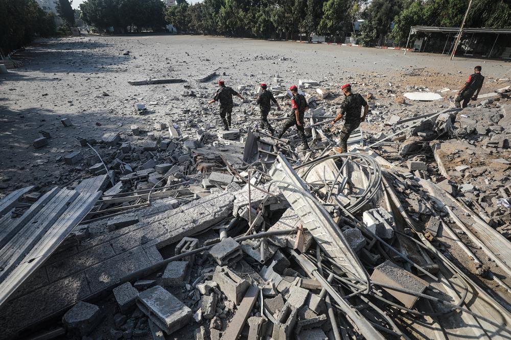 Security forces belonging to Hamas inspect the site after Israeli army conducted air strikes towards Gaza City on the grounds that 36 rockets were thrown to Israel in Gaza.