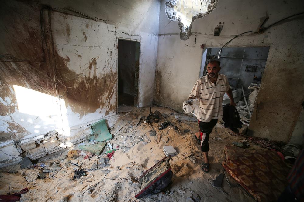 Palestinians insect the damage after warplanes belonging to Israeli army carried out an airstrike over residential areas in Deir Al-Balah, Gaza.