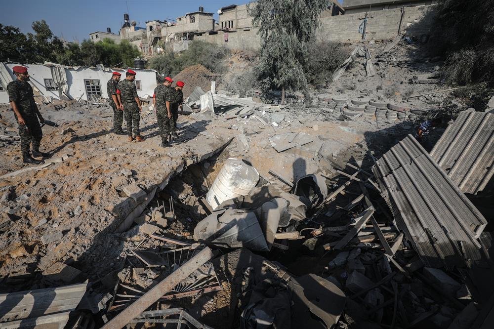 Security forces belonging to Hamas inspect the site after Israeli army conducted air strikes towards Gaza City on the grounds that 36 rockets were thrown to Israel in Gaza.