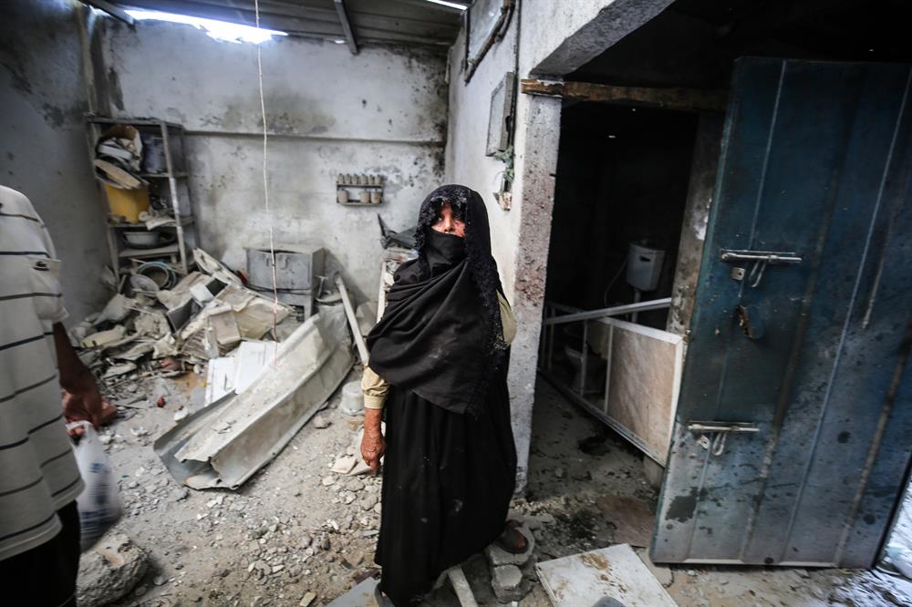 Palestinians insect the damage after warplanes belonging to Israeli army carried out an airstrike over residential areas in Deir Al-Balah, Gaza.
