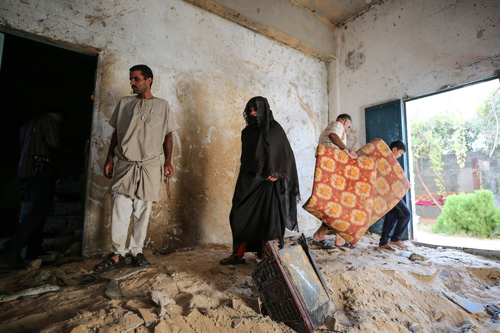 Palestinians insect the damage after warplanes belonging to Israeli army carried out an airstrike over residential areas in Deir Al-Balah, Gaza.