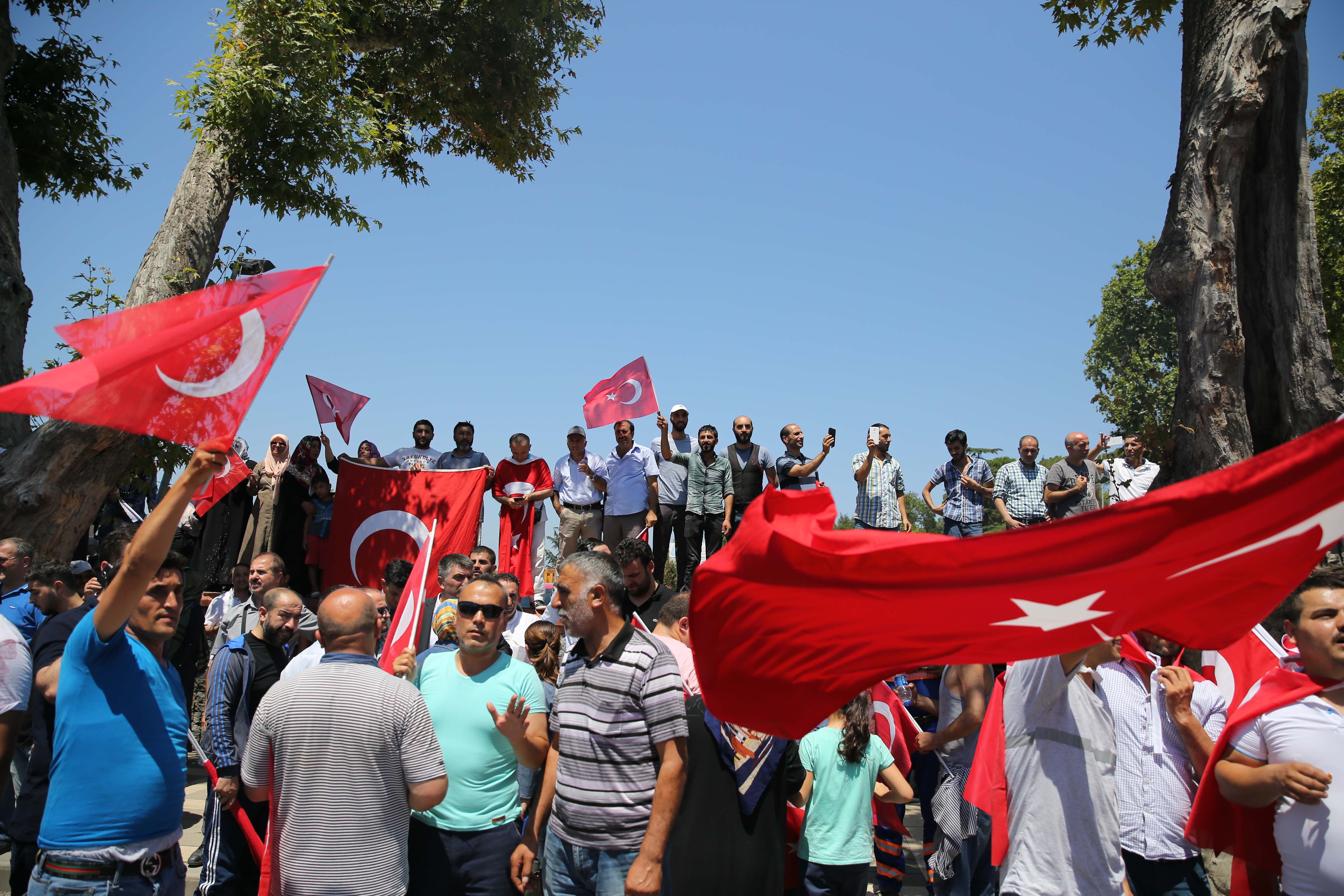 المواطنون يقومون بالحراسة وينتظرون بالأعلام التركية في أيديهم.